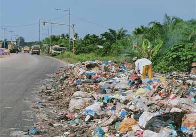 Sampah yang dibuang sembarangan mengganggu kebersihan dan pengguna jalan.