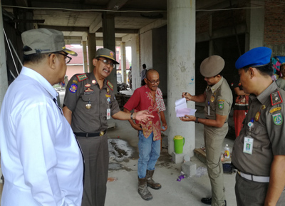  Kepala Satpol PP Dumai Bambang Wardoyo menghentikan pekerjaan pembangunan Hotel Platinum di Jalan Patimura Dumai lantaran belum punya izin. FOTO: Bambang