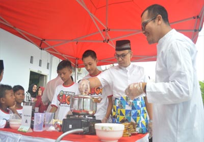 General Manager Sales Region Sumbagteng Telkomsel Ihsan (dua dari kiri) memasak takjil bersama anak-anak di Panti Asuhan Al Ilham Pekanbaru (20/5/2019).