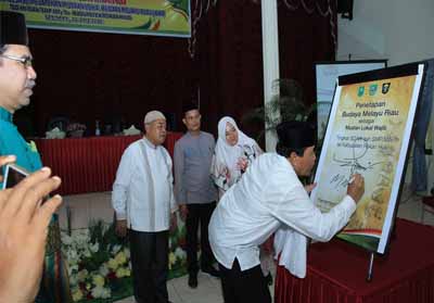 Bupati Sukiman didampingi Ketua Umum MKA LAM Riau Datuk Seri Al Azhar, Sekda Rohul, melakukan penandatanganan saat Sosialisasi dan Pelatihan Muatan Lokal Budaya Melau Riau (BMR), SD/MI dan MTs/SMP se-Rohul.