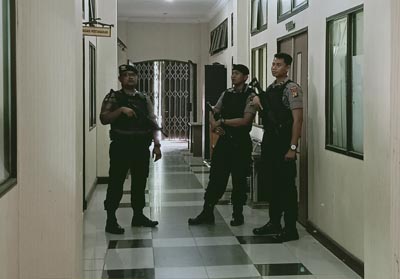 Tampak di depan pintu masuk ruangan bagian pengadaan barang dan jasa Setda Dumai dijaga ketat tiga orang petugas kepolisian bersenjata lengkap.