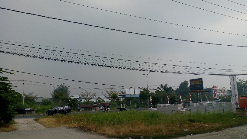 Jarak pandang berkurang terhalang kabut asap akibat Karhutla, seperti tampak di Jalan Soekarno-Hatta Kecamatan Payung Sekaki, Pekanbaru.