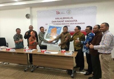 Ketua FKIJK Riau Irvandi Gustari selaku ketua periode yang lalu ( 2017- 2019), menerima cinderamata dari Kepala OJK Riau - Yusri 