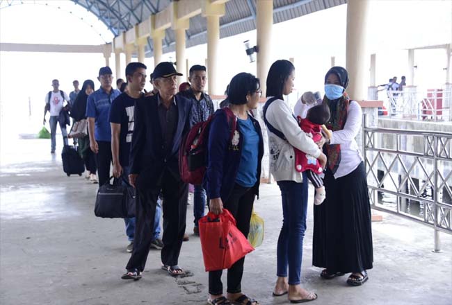 Petugas memeriksa suhu tubuh para penumpang yang baru saja tiba di Pelabuhan Bandar Sri Laksamana.