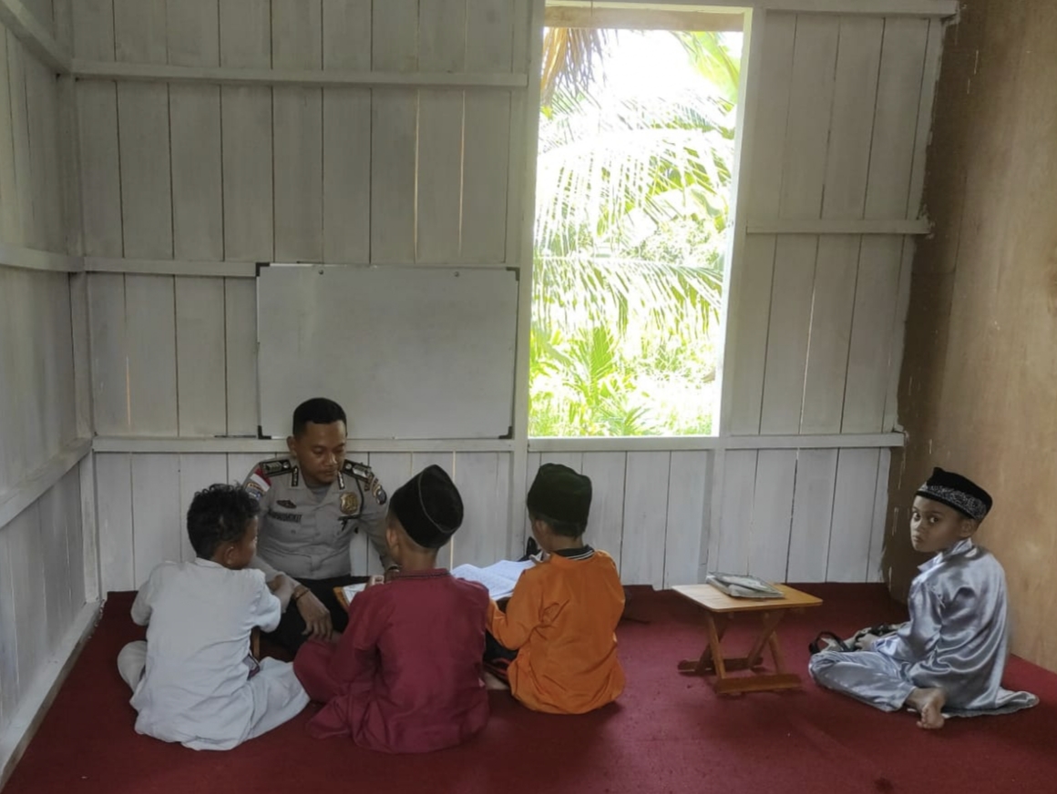 Bripka Suharmoko SE, Ps Kanit Binmas Polsek Rangsang Barat menyempatkan diri mengajar anak-anak mengaji