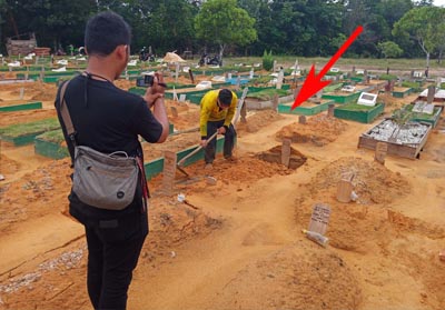 Tampak kuburan amblas ditimbun kembali oleh petugas