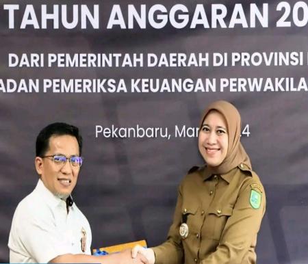 Bupati Inhu, Rezita Meylani saat menyerahkan LKPD Pemkab Inhu ke BPK Riau.(foto: andri/halloriau.com)