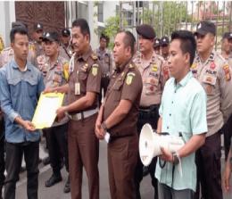 Massa menyerahkan surat pernyataan sikap ke Kasi Penkum Kejati Riau (foto/detakindonesia)