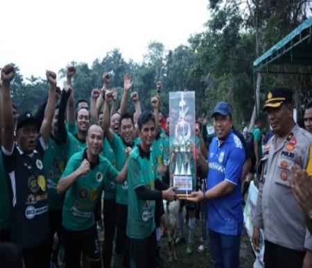 Wabup Siak, Husni Merza menyeahkan thropy kepada tim pemenang turnamen sepakbola antar RT se-Kelurahan Rempak.(foto: diana/halloriau.com)