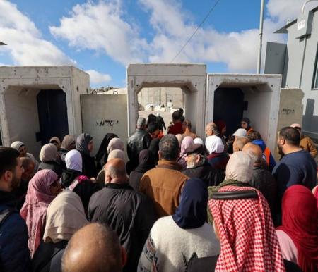Warga Palestina berbaris memasuki pos pemeriksaan Israel di Qalandia, di Tepi Barat, untuk menyeberang dan jalani salat Jumat di masjid Al Aqsa, Jumat (15/3/2024). Foto: Jaafar Ashtiyeh/AFP